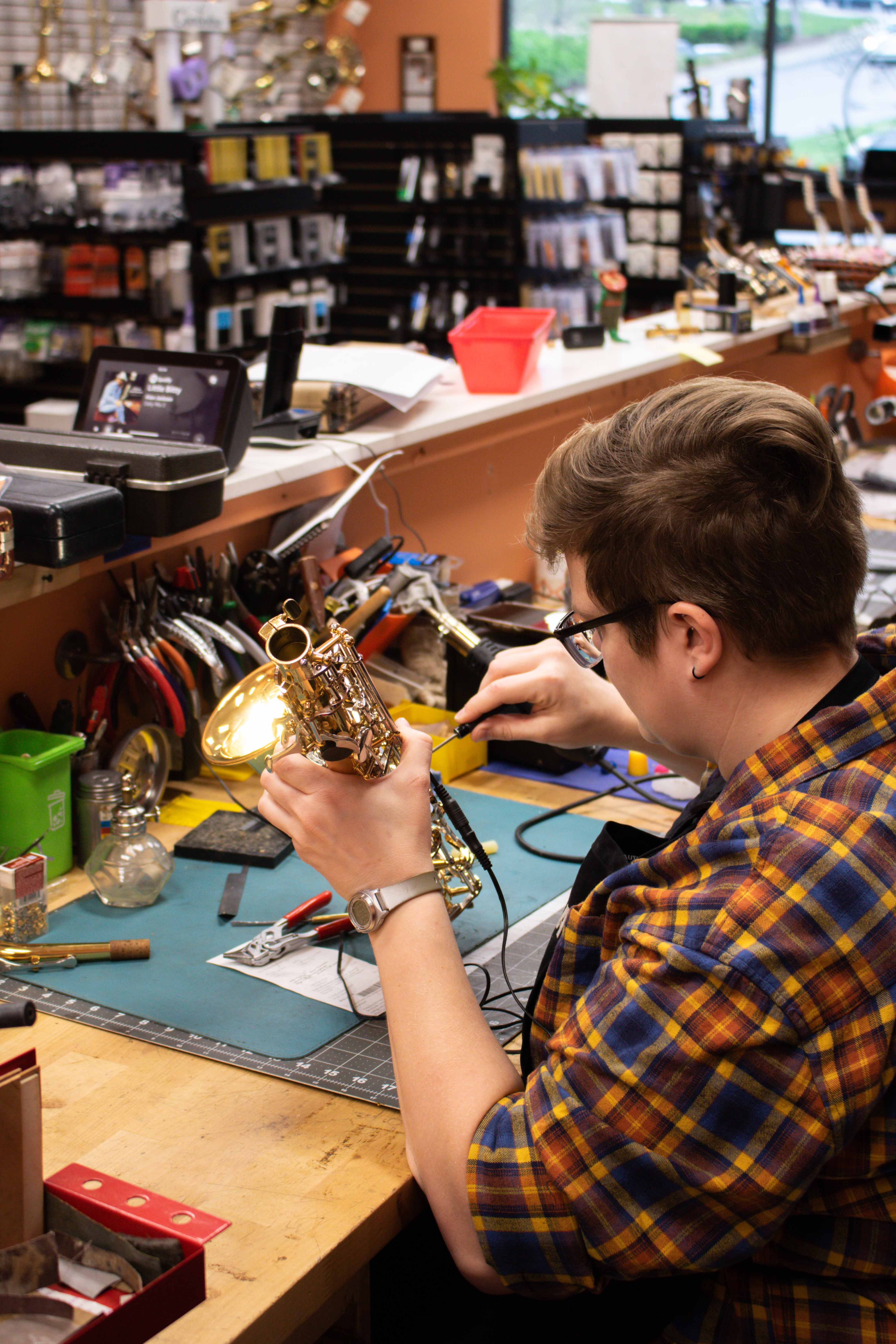 Lauren Repairing a Saxophone