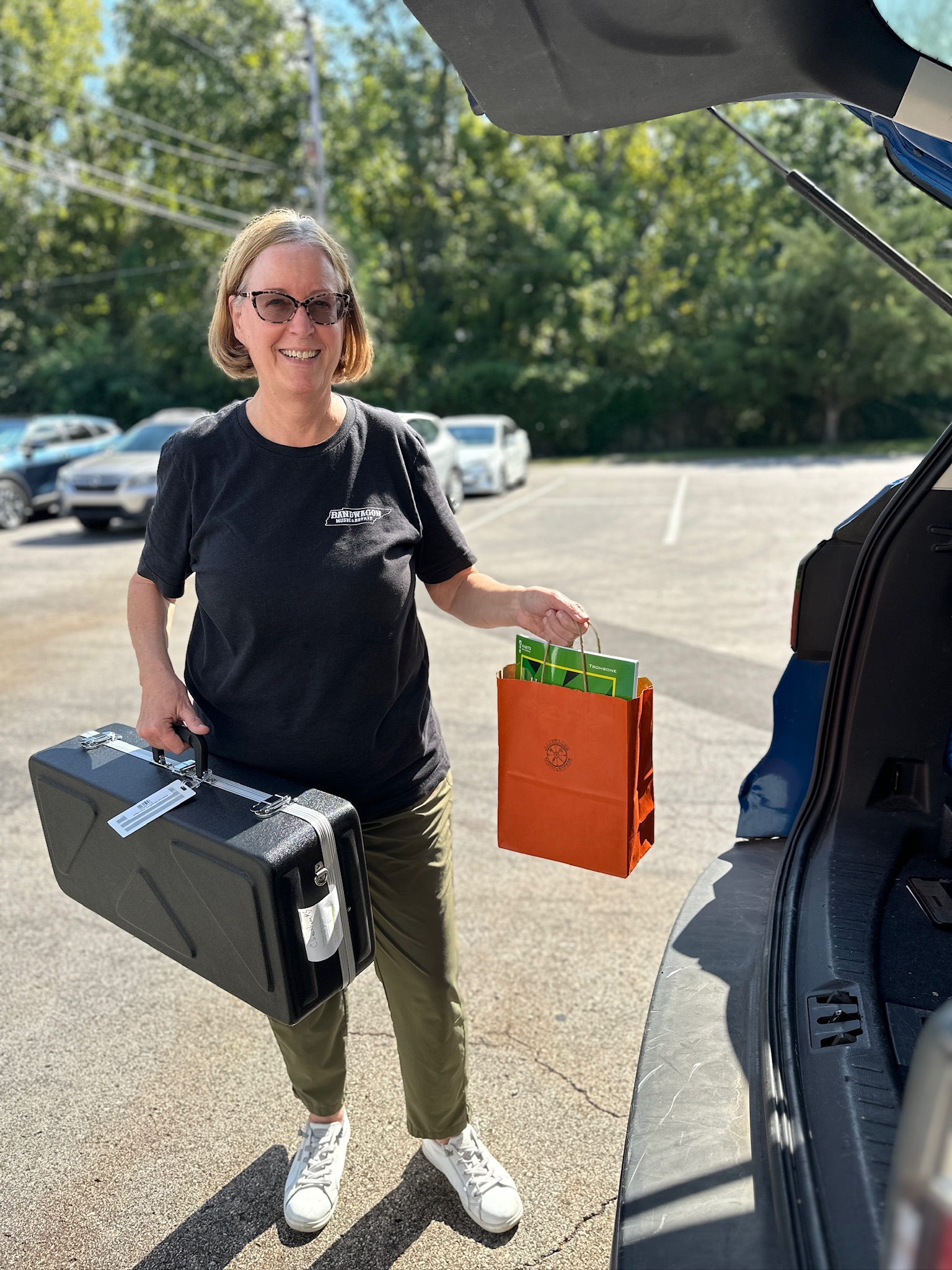 Laura Verdone carrying instrument accessories