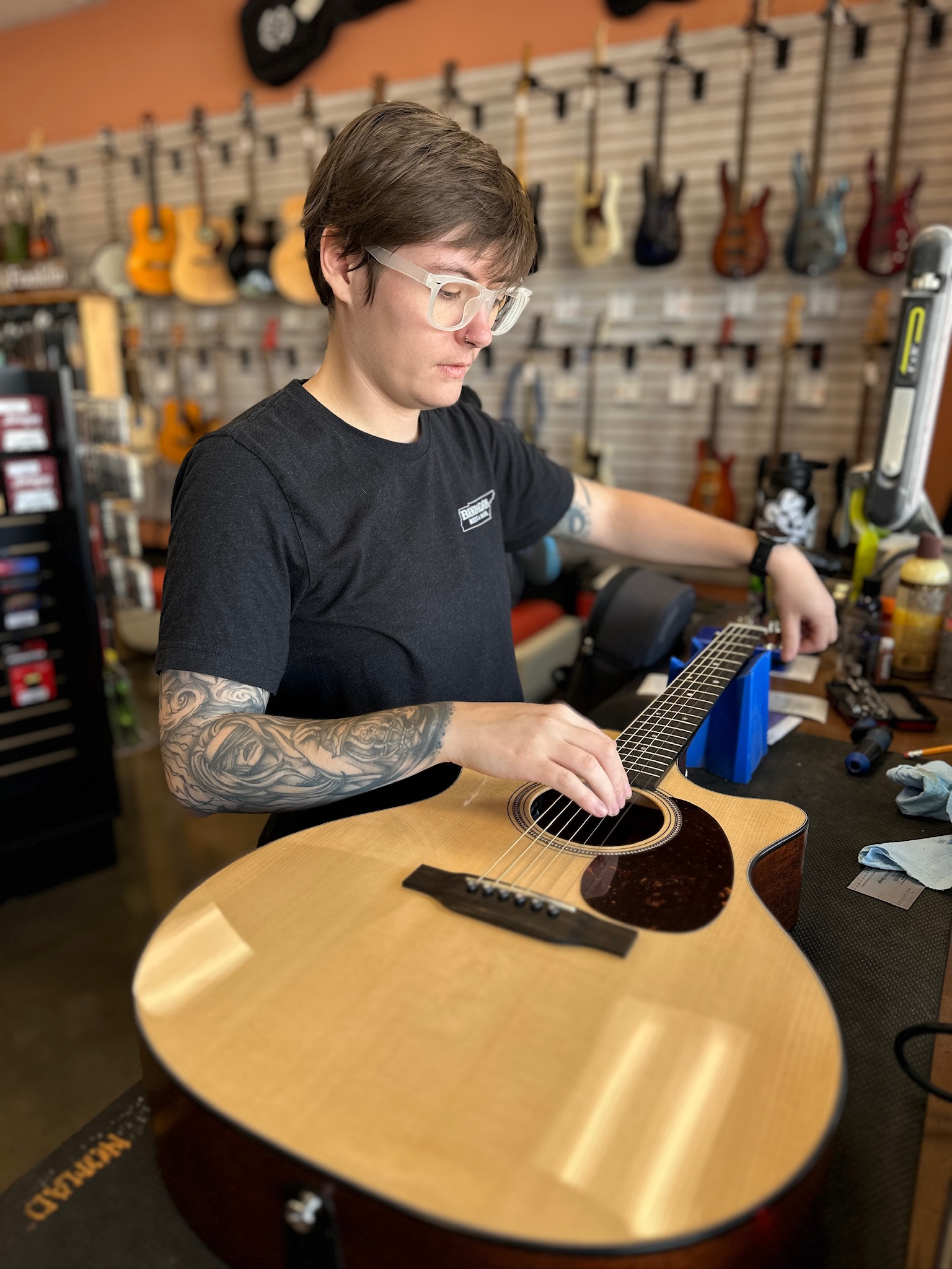 Sam Segar making a repair on a guitar
